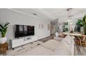 Well-lit living room showcasing a sofa, media center, and an adjacent dining area at 2161 Peachtree Ne Rd # 508, Atlanta, GA 30309