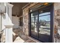 Elegant stone entryway with a large glass and iron double door, offering curb appeal and natural light at 789 Pathview Ct, Dacula, GA 30019