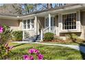 Lovely brick home featuring a blue front door, well-kept lawn, and mature azaleas at 1716 N Springs Dr, Atlanta, GA 30338