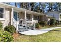 Classic brick home with a blue front door, leading to a well-manicured front yard at 1716 N Springs Dr, Atlanta, GA 30338