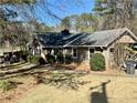 Landscaped single-story home featuring mature trees and an expansive, well-maintained yard at 3252 Westbrook Trce, Lawrenceville, GA 30044