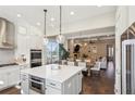 Open-concept kitchen featuring an island, modern appliances, and seamless flow to the dining area at 3332 Old Concord Se Rd, Smyrna, GA 30082