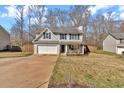 View of a two-story home with an attached garage, driveway, and well-maintained front lawn and fenced yard at 81 Summer Creek Dr, Dallas, GA 30157