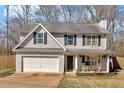 Charming two-story home with an attached garage and a cozy front porch featuring rocking chairs at 81 Summer Creek Dr, Dallas, GA 30157