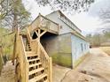 View of exterior of the house with staircase leading to upper deck area at 3110 Pope Rd, Douglasville, GA 30135