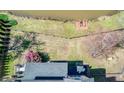 Aerial view of a well-maintained backyard with a wooden deck and a fence along the water at 5529 Camden Lake Pointe Nw, Acworth, GA 30101
