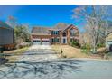 Charming two-story brick home with a well-manicured lawn and a three car garage at 5529 Camden Lake Pointe Nw, Acworth, GA 30101