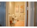 Cozy powder room featuring marble floors, pedestal sink, and artistic wall decor, providing a stylish and functional space at 7130 Oakley Ct, Union City, GA 30291