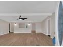 Open-concept living room with modern ceiling fan, archways, and new floors at 9180 Shiloh Dr, Villa Rica, GA 30180