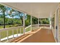 Covered porch with white railings offers a tranquil outdoor space with scenic views of nature at 9180 Shiloh Dr, Villa Rica, GA 30180