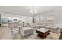 Spacious living room with large sectional sofa, stylish rug, and ample natural light at 114 Green Tree Ct, Dacula, GA 30019