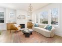 Bright living room with a decorative fireplace and large windows at 1453 Hartford Sw Ave, Atlanta, GA 30310