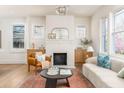 Sunlit living room with decorative fireplace, hardwood floors, and neutral décor at 1453 Hartford Sw Ave, Atlanta, GA 30310
