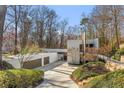 Beautiful exterior view of home with a two-car garage, modern architectural design, and lush landscaping at 535 Forest Hills Ne Dr, Atlanta, GA 30342