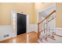 Bright foyer with hardwood floors, wainscoting, and staircase at 1039 Ashfern Walk, Woodstock, GA 30189