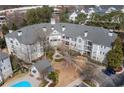 Aerial view of Vinings Vineyard Condominiums, featuring manicured grounds and blue swimming pool at 4100 Paces Se Walk # 2205, Atlanta, GA 30339