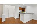 Inviting entry leading to kitchen with hardwood floors and elegant columns at 4100 Paces Se Walk # 2205, Atlanta, GA 30339