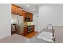 Kitchen with stainless steel appliances, wooden cabinets, and a stylish sink at 4100 Paces Se Walk # 2205, Atlanta, GA 30339
