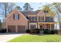 Attractive two-story home boasting a manicured lawn and a welcoming front porch at 5383 Fawn Meadow Ln, Powder Springs, GA 30127