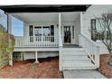 Welcoming front porch featuring white pillars and a beautifully bricked entryway, perfect for relaxing at 1285 Cedar Brook Dr, Lawrenceville, GA 30043