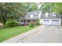 Classic two-story home featuring a welcoming front porch and attached garage at 5500 Georgetown Sw Trce, Lilburn, GA 30047
