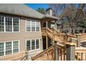 Inviting exterior view showcasing a two-story home with wooden decks and lots of windows for natural light at 303 Mill Pond Se Ct, Smyrna, GA 30082
