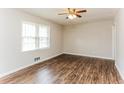 Cozy bedroom with natural light, laminate floors, a ceiling fan, and neutral paint at 3588 Swallow Ln, Decatur, GA 30032
