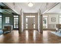 Elegant foyer featuring hardwood floors, detailed molding, and a front door with sidelights for natural light at 111 Carter Ln, Canton, GA 30115