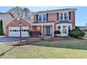 Attractive two-story brick home with an attached garage, landscaped front yard, and inviting front entrance at 2940 Abbotts Pointe Dr, Duluth, GA 30097