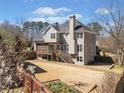 Two-story home showcasing the backyard and wooden deck, perfect for relaxation and entertaining at 918 Fox Hollow Way, Marietta, GA 30068