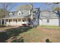 Charming single-story home featuring a covered porch, dormer windows, and a well-maintained front lawn at 75 Price Dr, Locust Grove, GA 30248