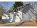 Spacious three-car garage with white doors, ideal for vehicle storage and workshop space at 75 Price Dr, Locust Grove, GA 30248