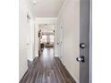 Inviting hallway featuring hardwood floors, neutral walls, and a view into the brightly lit living area at 146 Point View Dr, Canton, GA 30114