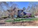 Charming brick home boasts lush greenery and a meticulously maintained lawn, creating curb appeal at 2030 Habersham Trce, Cumming, GA 30041