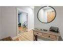 Hallway featuring hardwood floors and a view of a living area; decorated with a modern table and mirror at 1029 Piedmont Ne Ave # 305, Atlanta, GA 30309