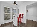 Bright breakfast nook with large window, modern ceiling fan, and stylish red chairs at 1923 Ivy Glen Se Dr, Smyrna, GA 30082