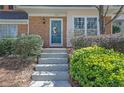 Close-up of the front entrance featuring a teal door, wreath, and concrete steps at 1923 Ivy Glen Se Dr, Smyrna, GA 30082