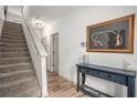 Bright foyer with staircase, modern console table, decorative artwork, and luxury vinyl plank flooring at 3651 Princeton Ave, Atlanta, GA 30337