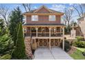 Attractive two-story home with a charming porch, featuring a convenient two-car garage and landscaped surroundings at 1211 Thornwell Ne Dr, Brookhaven, GA 30319