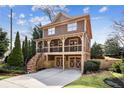 Beautiful two-story home with a covered porch and two-car garage, accented by stone detailing and lush landscaping at 1211 Thornwell Ne Dr, Brookhaven, GA 30319