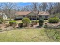 Quaint single-story home with mature landscaping and a well-maintained front lawn at 133 Hickory Trl, Cumming, GA 30040