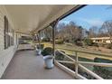 Cozy covered porch with a swing and serene views of the landscaped yard at 133 Hickory Trl, Cumming, GA 30040