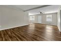 Bright living room featuring wood-look flooring, neutral paint, ceiling fan, and ample natural light at 2911 Botany Dr, Jonesboro, GA 30236
