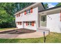 Close-up of home's entrance, features a well-maintained lawn, gray steps, and olive front door at 1893 Burning Tree Dr, Decatur, GA 30032