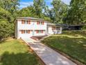 Beautiful exterior view of home featuring lush greenery and long drive way at 1893 Burning Tree Dr, Decatur, GA 30032