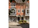 Charming townhouse exterior showcasing a tidy yard, muted colors, and convenient garage access to each home at 380 Grant Se Cir # 306, Atlanta, GA 30315