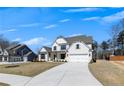 Well-maintained two-story home showcasing a light brick exterior, a covered entryway, and a spacious driveway leading to the garage at 4732 Cooling Water Cir, Powder Springs, GA 30127