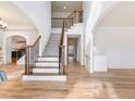Bright foyer with hardwood floors and an open staircase with decorative iron railing at 2536 Kachina Trl, Dacula, GA 30019