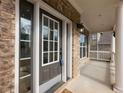 Close-up of front entry with sidelights and covered porch with columns at 2536 Kachina Trl, Dacula, GA 30019