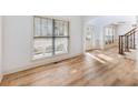 Bright open-concept living room with hardwood floors and large windows at 2536 Kachina Trl, Dacula, GA 30019